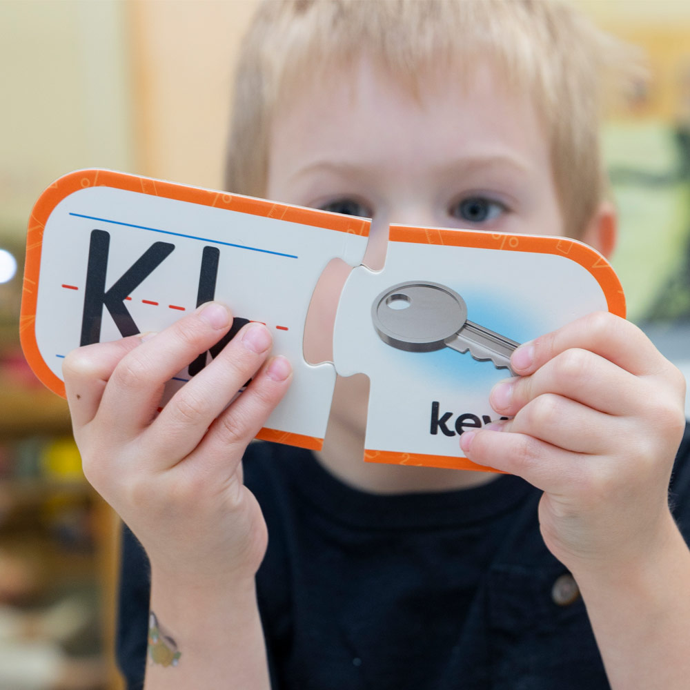 Young student putting a puzzle together
