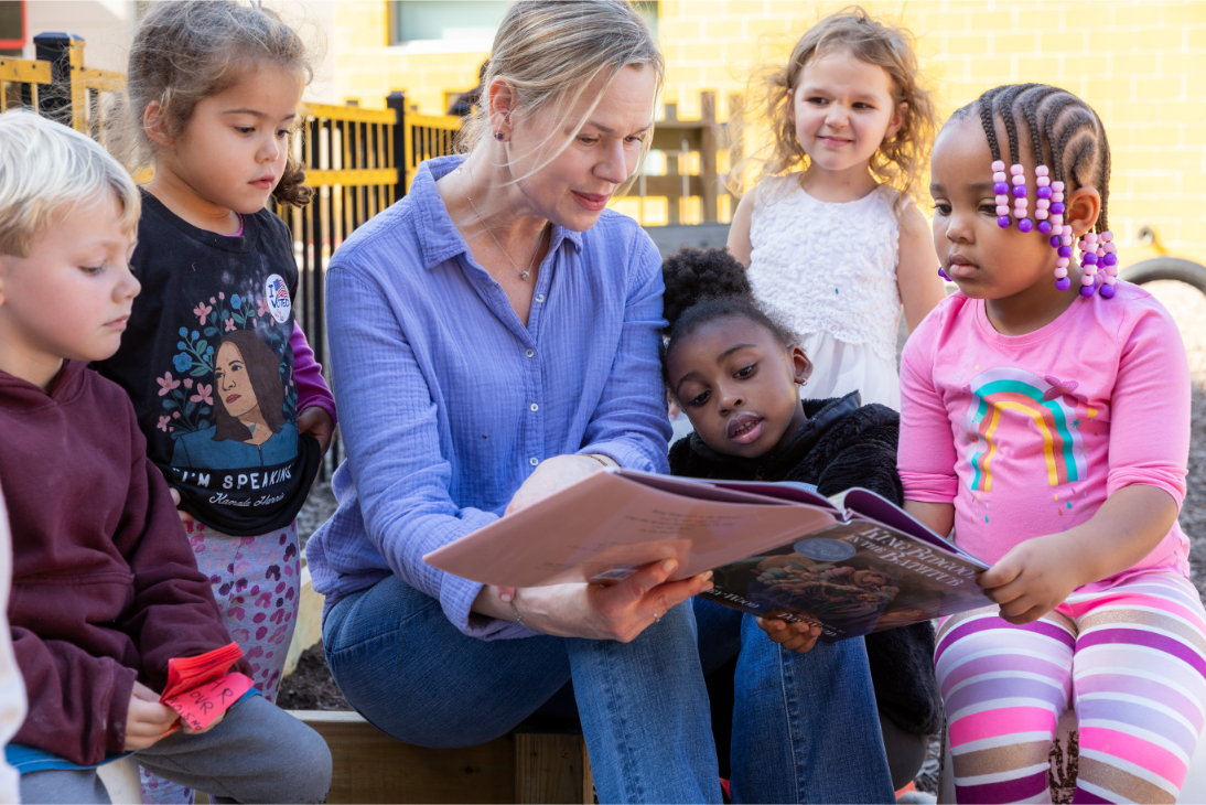 Lisa Howard reading a book to children.