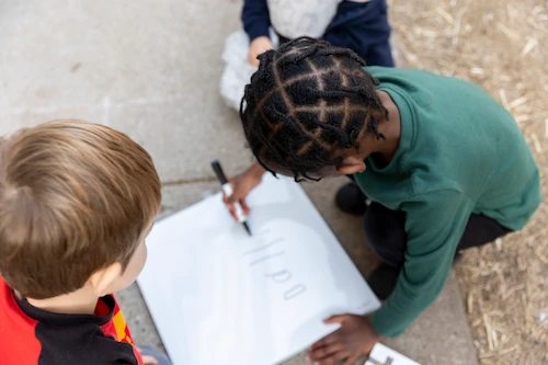 Teacher working with young students