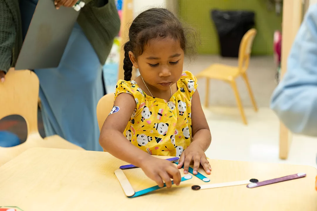 Teacher working with young students
