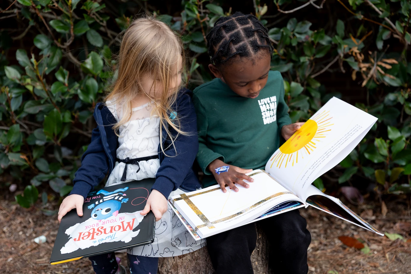 Lisa Howard reading a book to children.